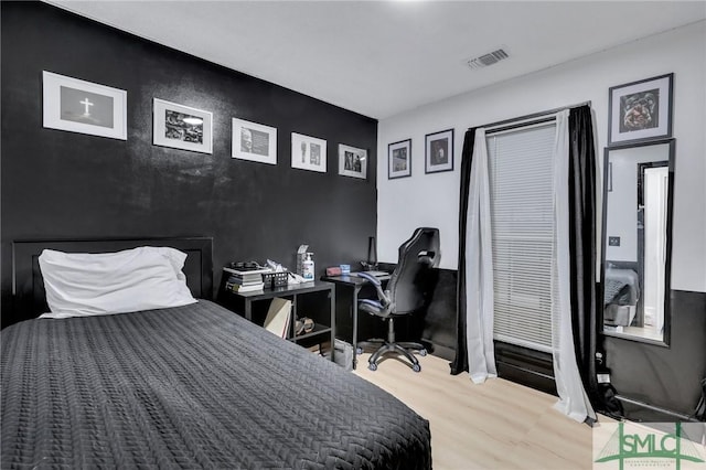 bedroom with hardwood / wood-style floors