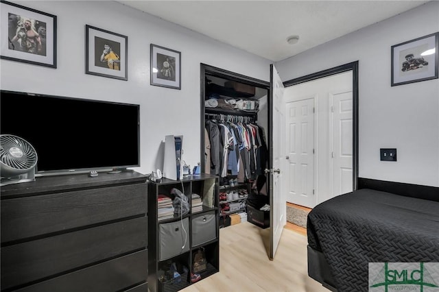 bedroom with a closet and light hardwood / wood-style floors