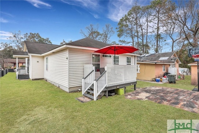 rear view of property featuring a lawn