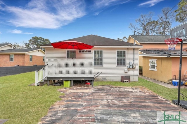 back of property featuring a yard and a wooden deck