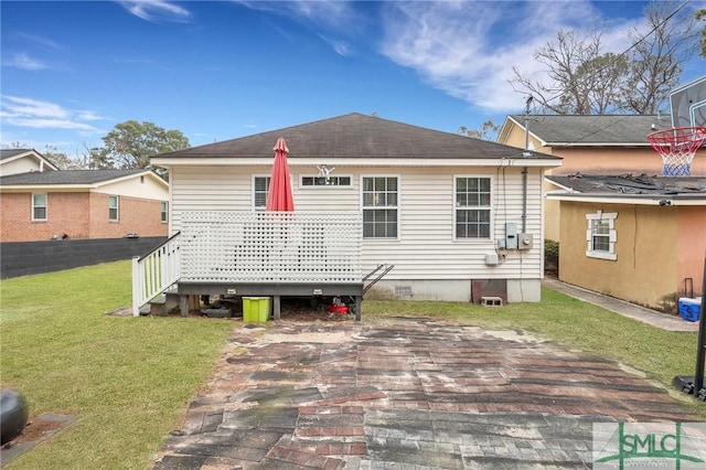 rear view of house with a patio area and a yard