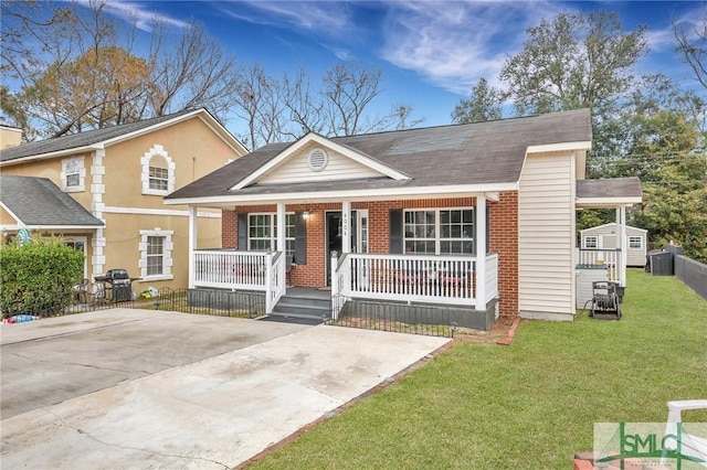 view of front of home featuring covered porch, central AC unit, and a front yard