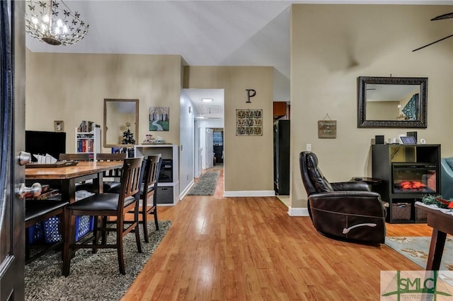 dining area with hardwood / wood-style floors and a notable chandelier