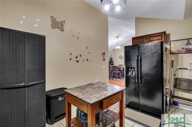 kitchen featuring light tile patterned flooring, lofted ceiling, black refrigerator with ice dispenser, and an inviting chandelier