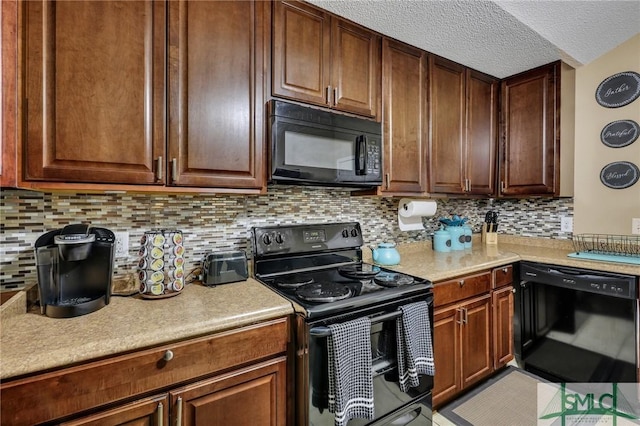 kitchen with decorative backsplash, light tile patterned flooring, black appliances, and a textured ceiling