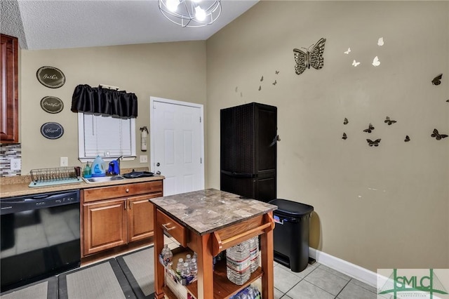 kitchen with dishwasher, light tile patterned floors, a textured ceiling, and vaulted ceiling