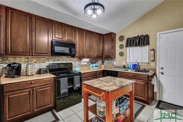 kitchen featuring black appliances, lofted ceiling, light tile patterned floors, and backsplash