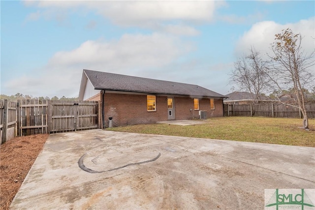 back of property with a yard, a patio, and central AC unit