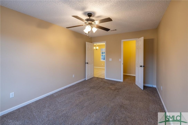 unfurnished bedroom featuring a textured ceiling, light colored carpet, and ceiling fan with notable chandelier