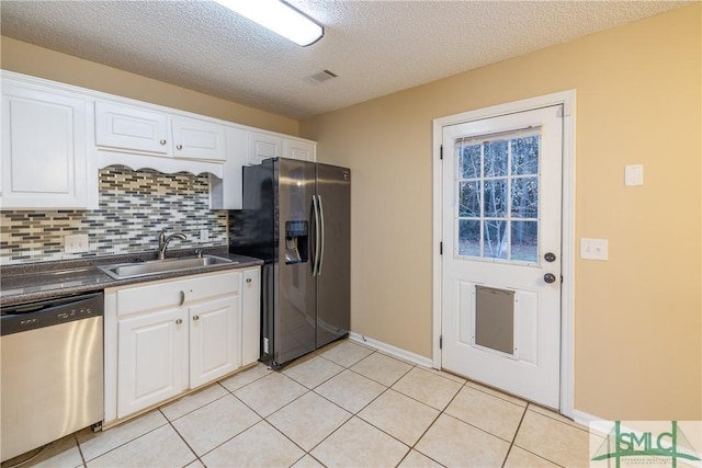 kitchen with a textured ceiling, sink, white cabinetry, and stainless steel appliances