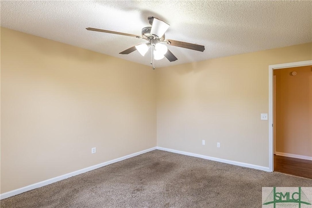 carpeted empty room featuring ceiling fan and a textured ceiling