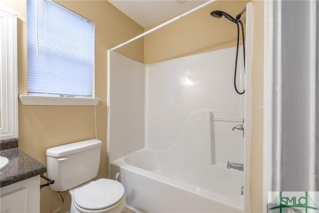 full bathroom featuring vanity, a healthy amount of sunlight, a textured ceiling, and toilet