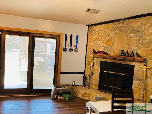 interior space with a fireplace and dark hardwood / wood-style floors