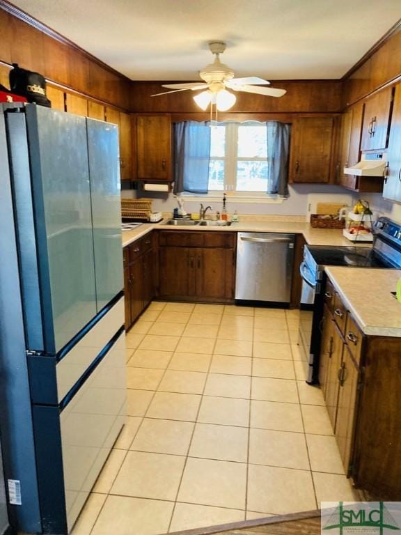 kitchen featuring dishwasher, sink, black electric range oven, ventilation hood, and fridge