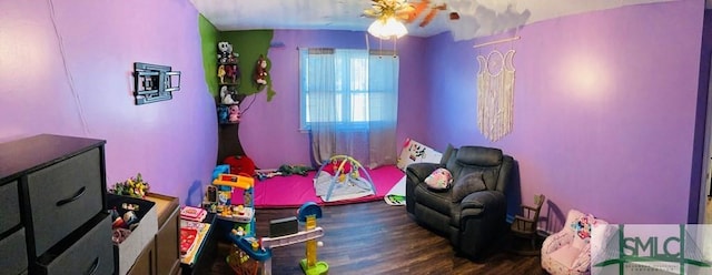 game room with ceiling fan and dark wood-type flooring