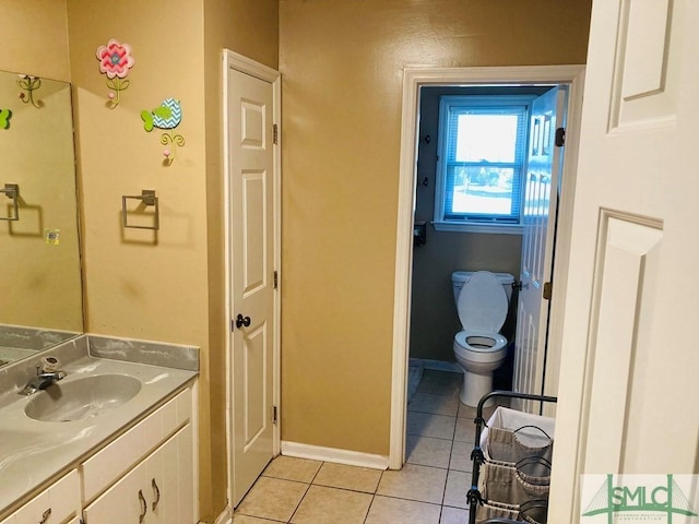 bathroom featuring tile patterned flooring, vanity, and toilet