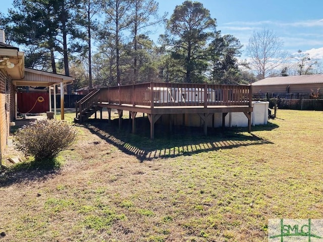 rear view of house with a wooden deck and a yard