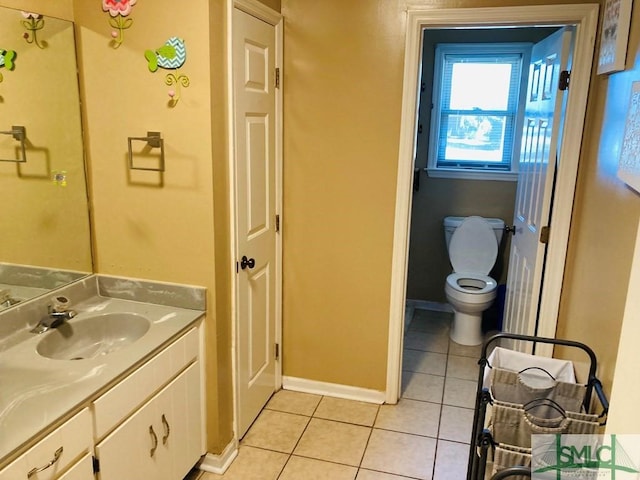 bathroom featuring tile patterned flooring, vanity, and toilet