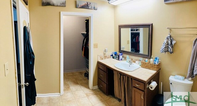 bathroom with tile patterned floors, vanity, and toilet