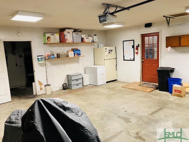 garage with white refrigerator, a garage door opener, and refrigerator