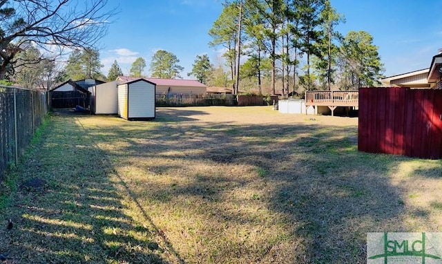 view of yard featuring a storage shed and a deck