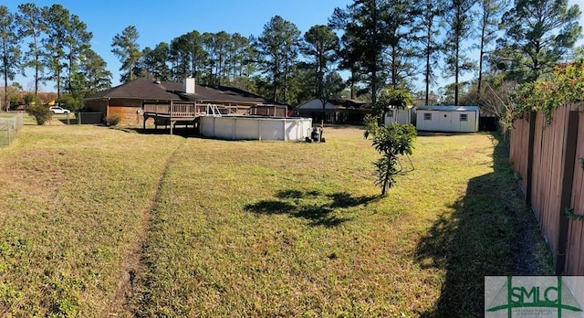 view of yard featuring a pool side deck and a shed