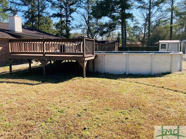 view of yard with a wooden deck and a storage unit