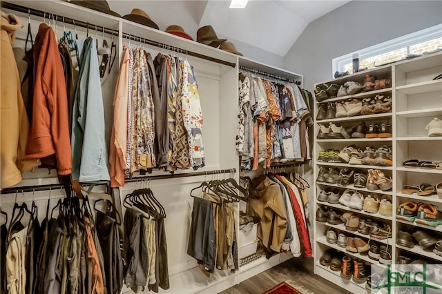 spacious closet with wood-type flooring and vaulted ceiling