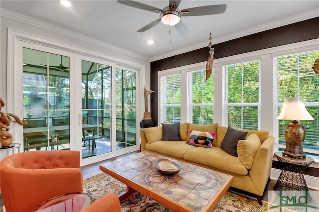 sunroom / solarium featuring ceiling fan