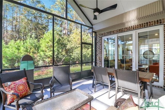 sunroom featuring ceiling fan and vaulted ceiling