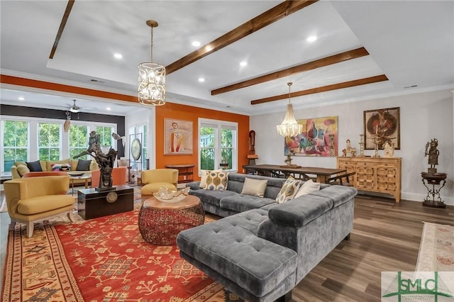 living room featuring a tray ceiling, ceiling fan, crown molding, and wood-type flooring