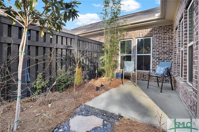 view of patio featuring fence