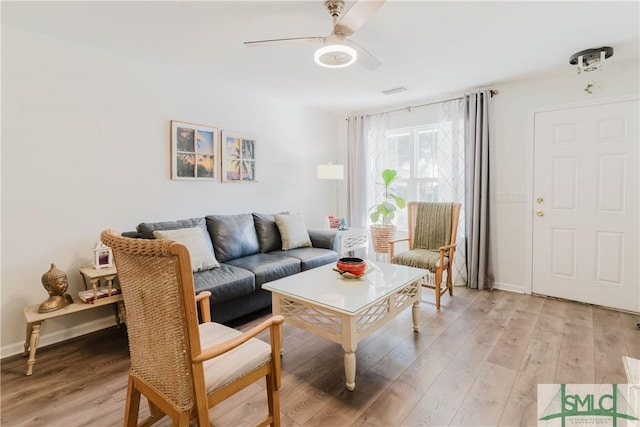 living room featuring light hardwood / wood-style floors and ceiling fan