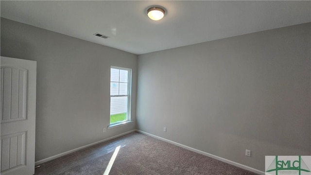 unfurnished room featuring carpet floors, visible vents, and baseboards