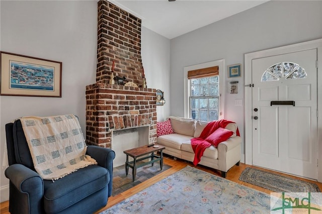 entryway with a fireplace and hardwood / wood-style flooring