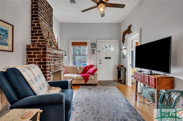 living room featuring ceiling fan and light wood-type flooring