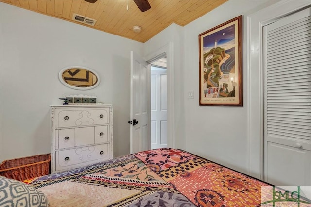 bedroom with a closet, ceiling fan, and wood ceiling