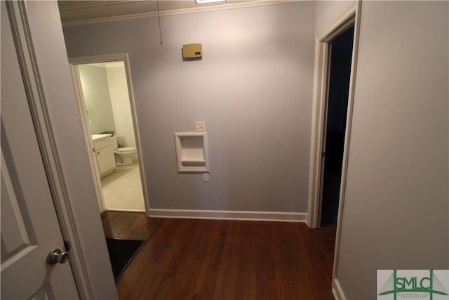 hall with dark wood-type flooring and ornamental molding