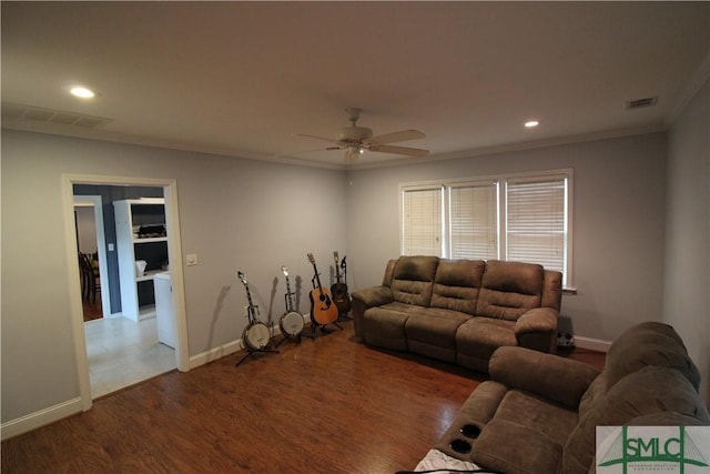 living room featuring hardwood / wood-style floors, ceiling fan, and crown molding