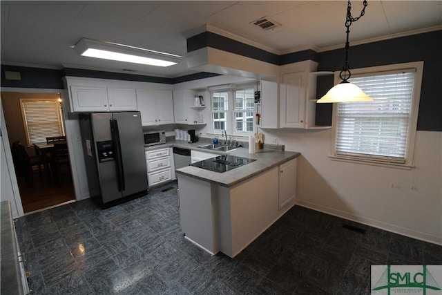 kitchen with kitchen peninsula, appliances with stainless steel finishes, sink, white cabinets, and hanging light fixtures