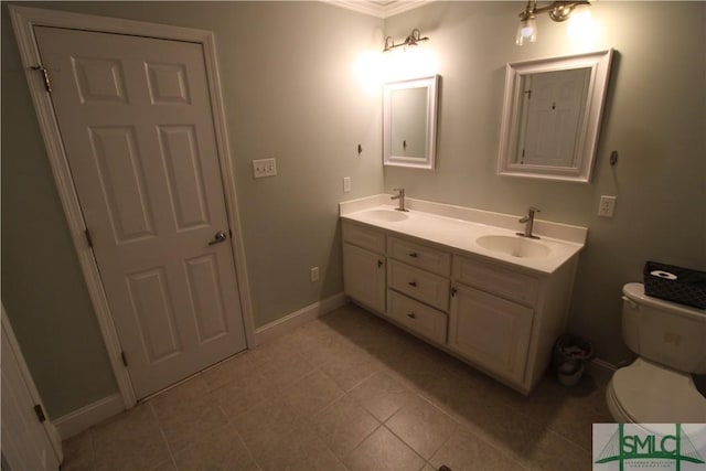 bathroom with vanity, toilet, and crown molding