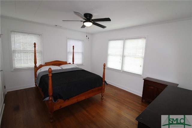 bedroom with ceiling fan, ornamental molding, and dark wood-type flooring