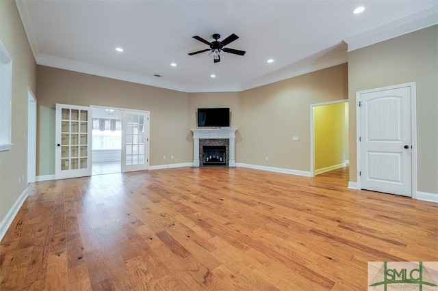 unfurnished living room featuring ceiling fan, light hardwood / wood-style flooring, and ornamental molding