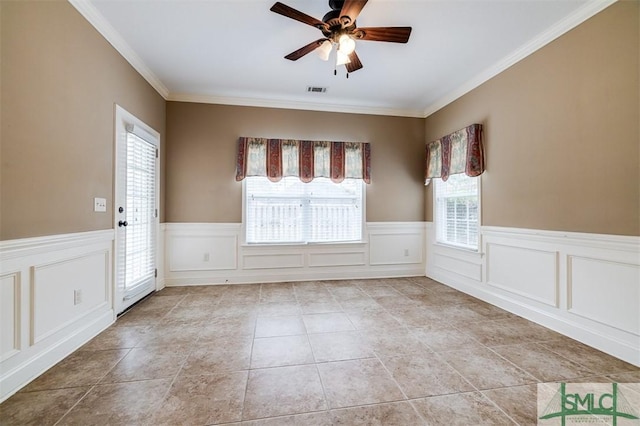 tiled spare room with ceiling fan and crown molding