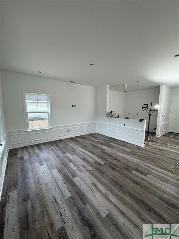 unfurnished living room featuring dark hardwood / wood-style floors