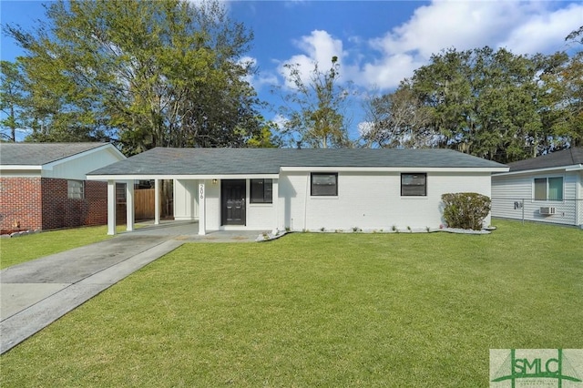 single story home with a front yard and a carport