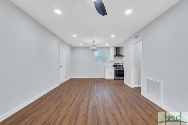 unfurnished living room featuring dark hardwood / wood-style floors and a notable chandelier