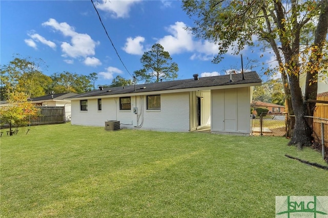 rear view of property with a lawn