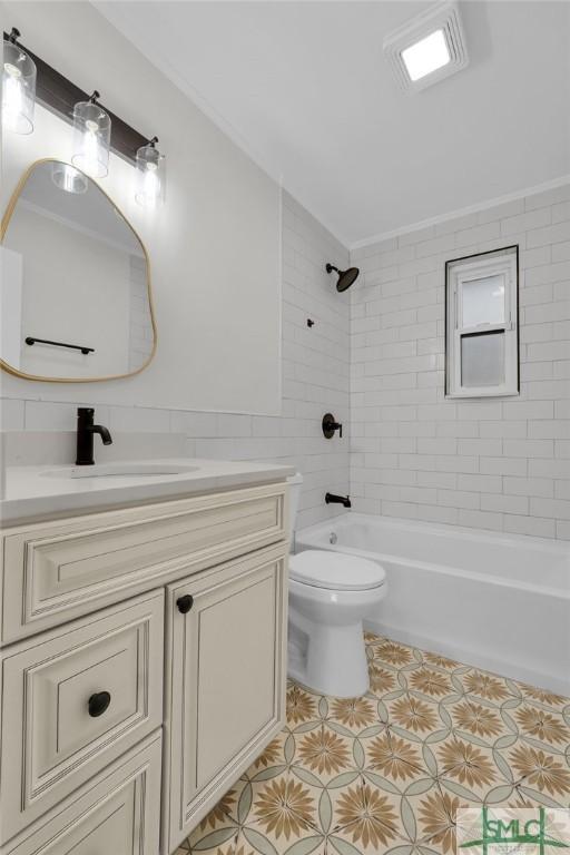 full bathroom featuring vanity, toilet, and tiled shower / bath