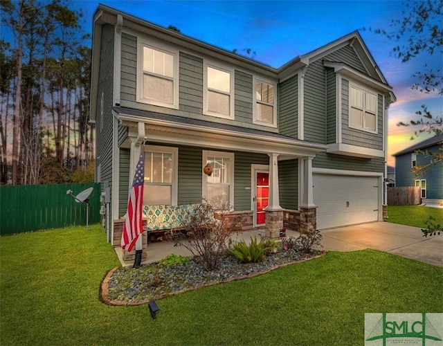 view of front facade featuring a garage and a lawn